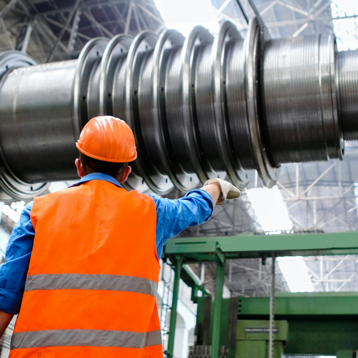 Ambiente industrial com operador e equipamento de grande porte